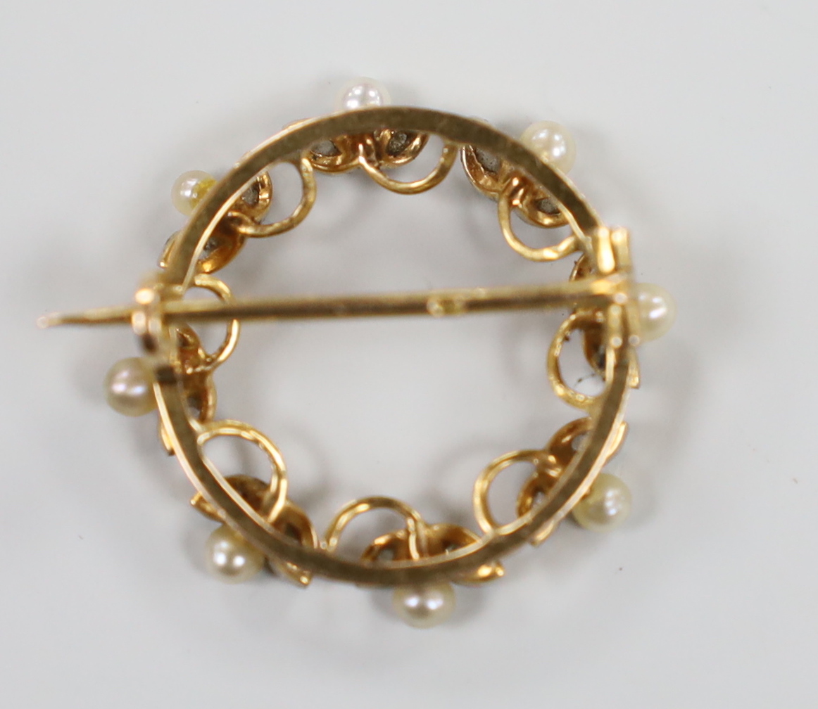 A late 19th century French yellow metal (18ct poincon mark), seed pearl and rose cut diamond set open work brooch, 23mm, gross weight 3.7 grams.